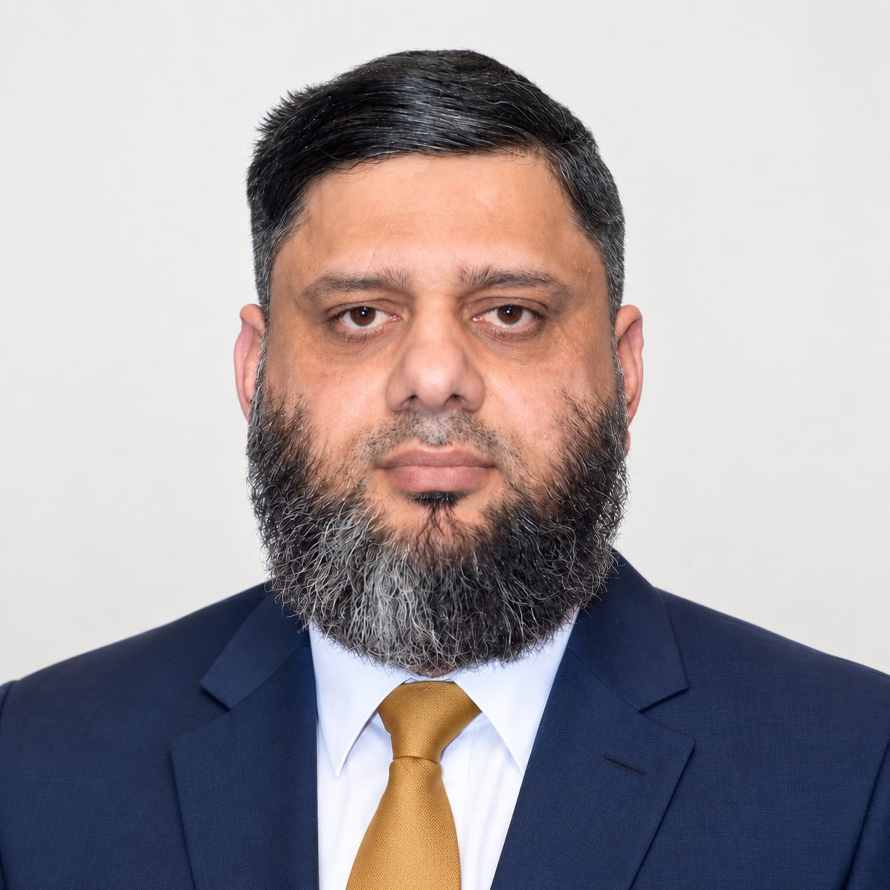 Portrait of Dr. Ahmed Ejaz in a navy suit and gold tie