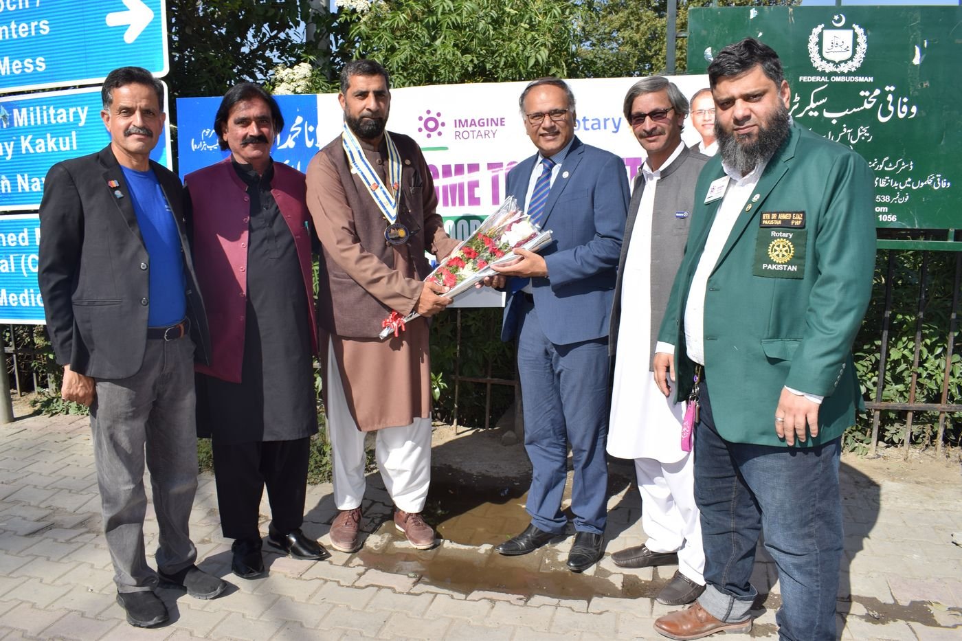 Dr. Ahmed Ejaz in a Rotary Pakistan blazer with Rotarians at an Imagine Rotary welcome