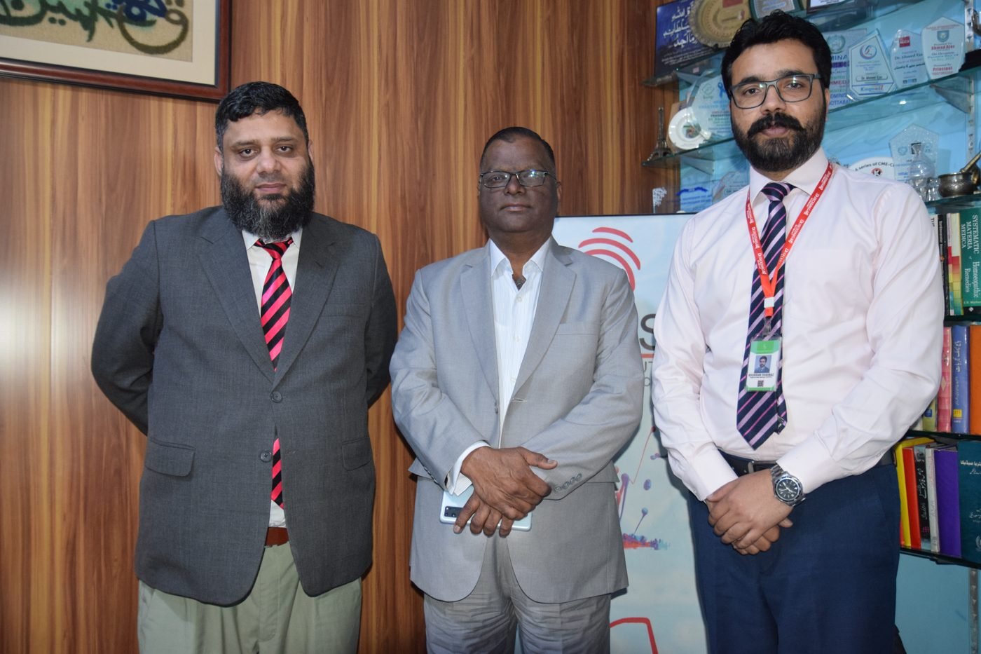 Dr. Ahmed Ejaz with two guests in his office