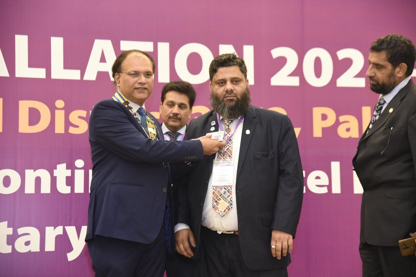 District Governor pinning Dr. Ahmed Ejaz as Assistant Governor